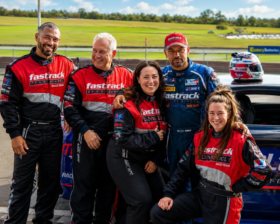 Corporate group in racing suits